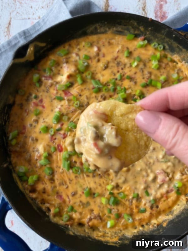 Ultimate Sausage Cheese Dip 8 Sausage Cheese Dip with tortilla chips on a wooden board