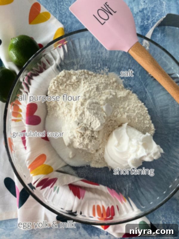 Ingredients for Key Lime Slab Pie crust laid out: flour, sugar, salt, shortening, an egg yolk, and milk.
