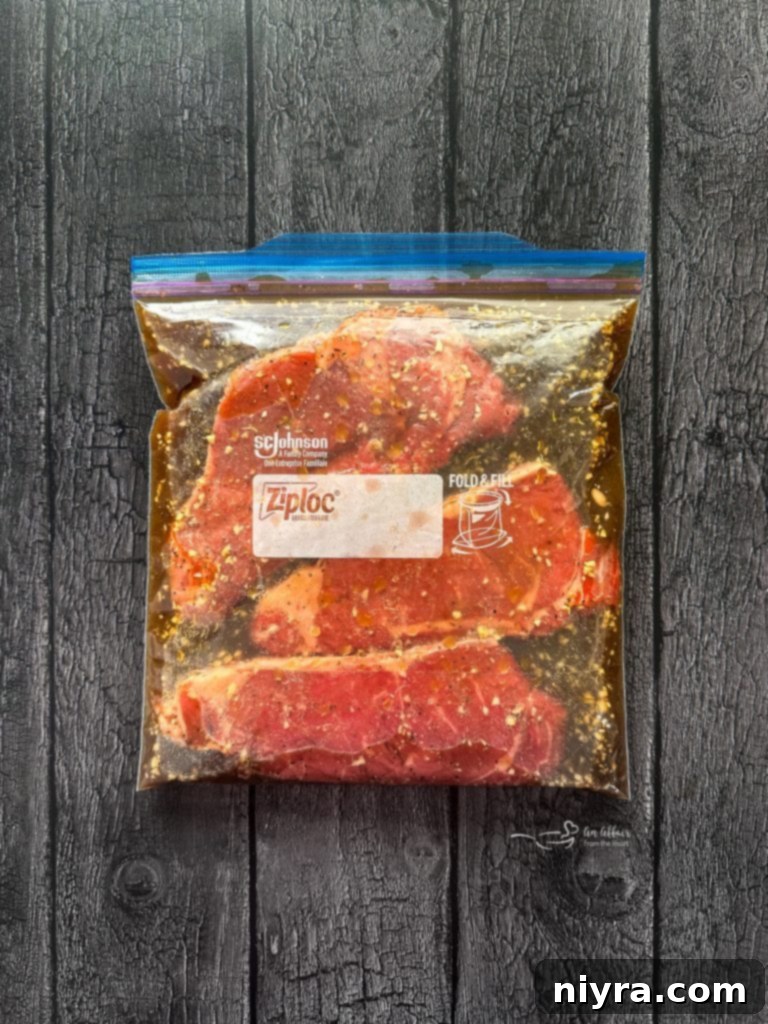 A bowl of mixed marinade ingredients with a whisk.