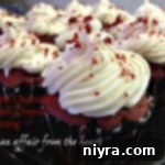 Side view of white chocolate cream cheese frosting on cupcakes