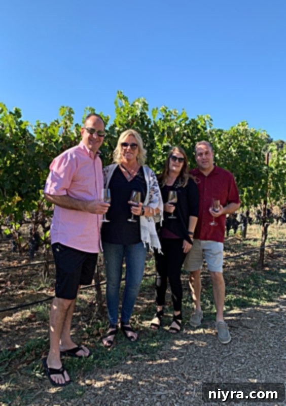 Four people standing in vineyard at Fontanella Winery