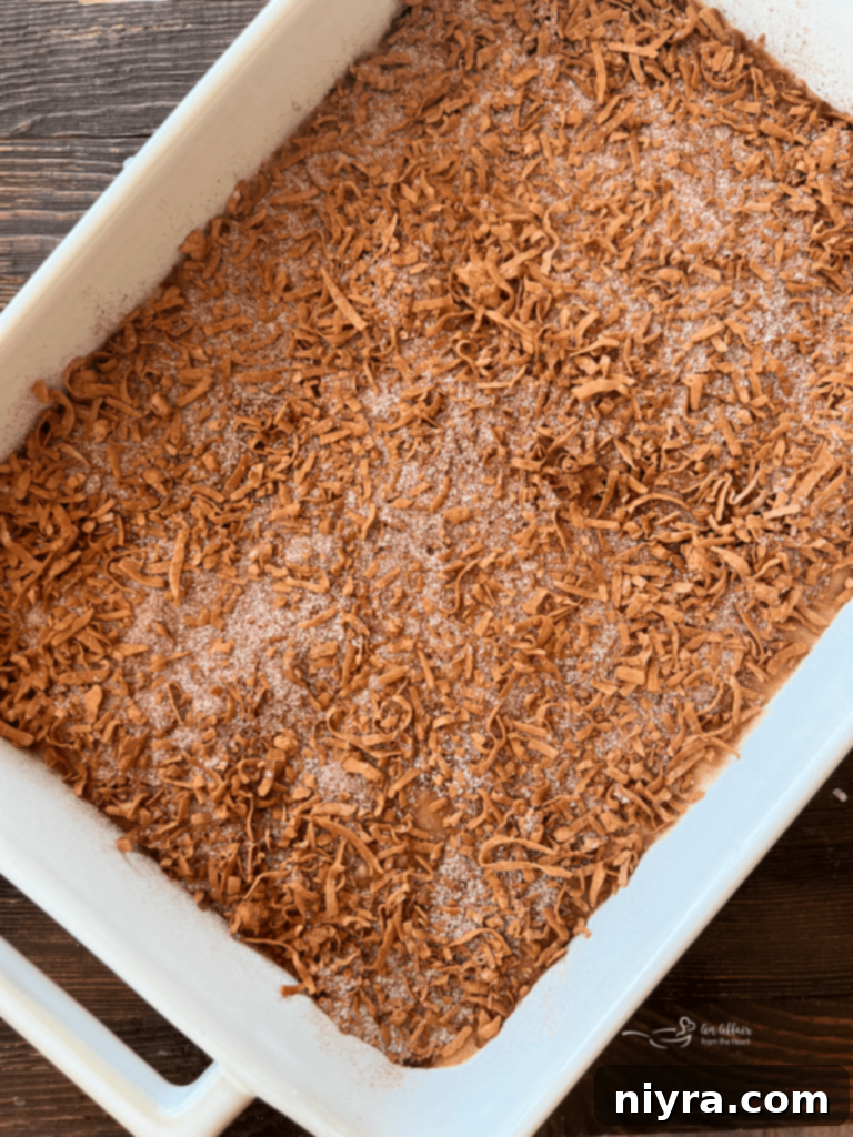 Sweet and Tart Rhubarb Bliss 12 Cake batter poured into a prepared baking dish.