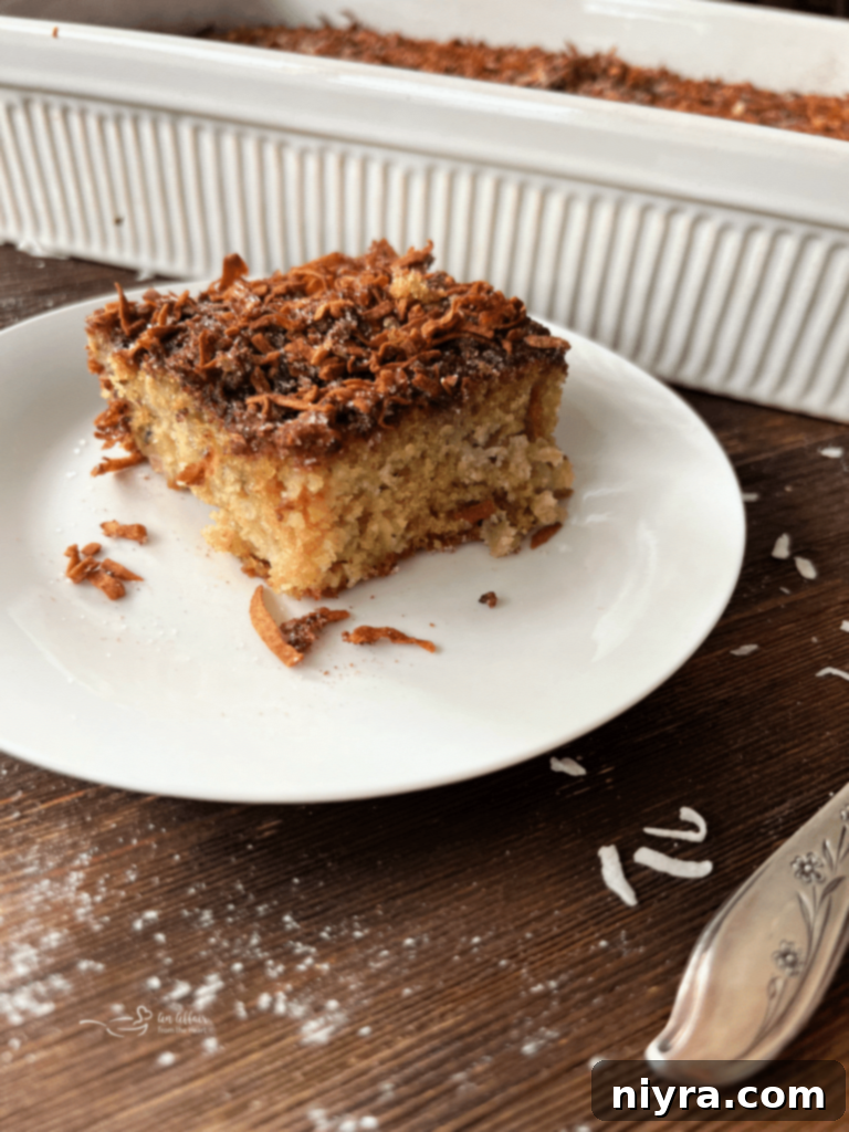 Sweet and Tart Rhubarb Bliss 15 A close-up of a slice of rhubarb cake on a white plate, with a fork.