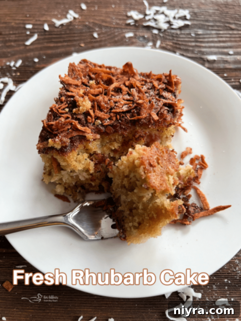 Sweet and Tart Rhubarb Bliss 16 A beautifully presented whole rhubarb cake with a slice removed.