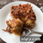 Sweet and Tart Rhubarb Bliss 18 Cutting into a piece of Fresh rhubarb cake with a fork.