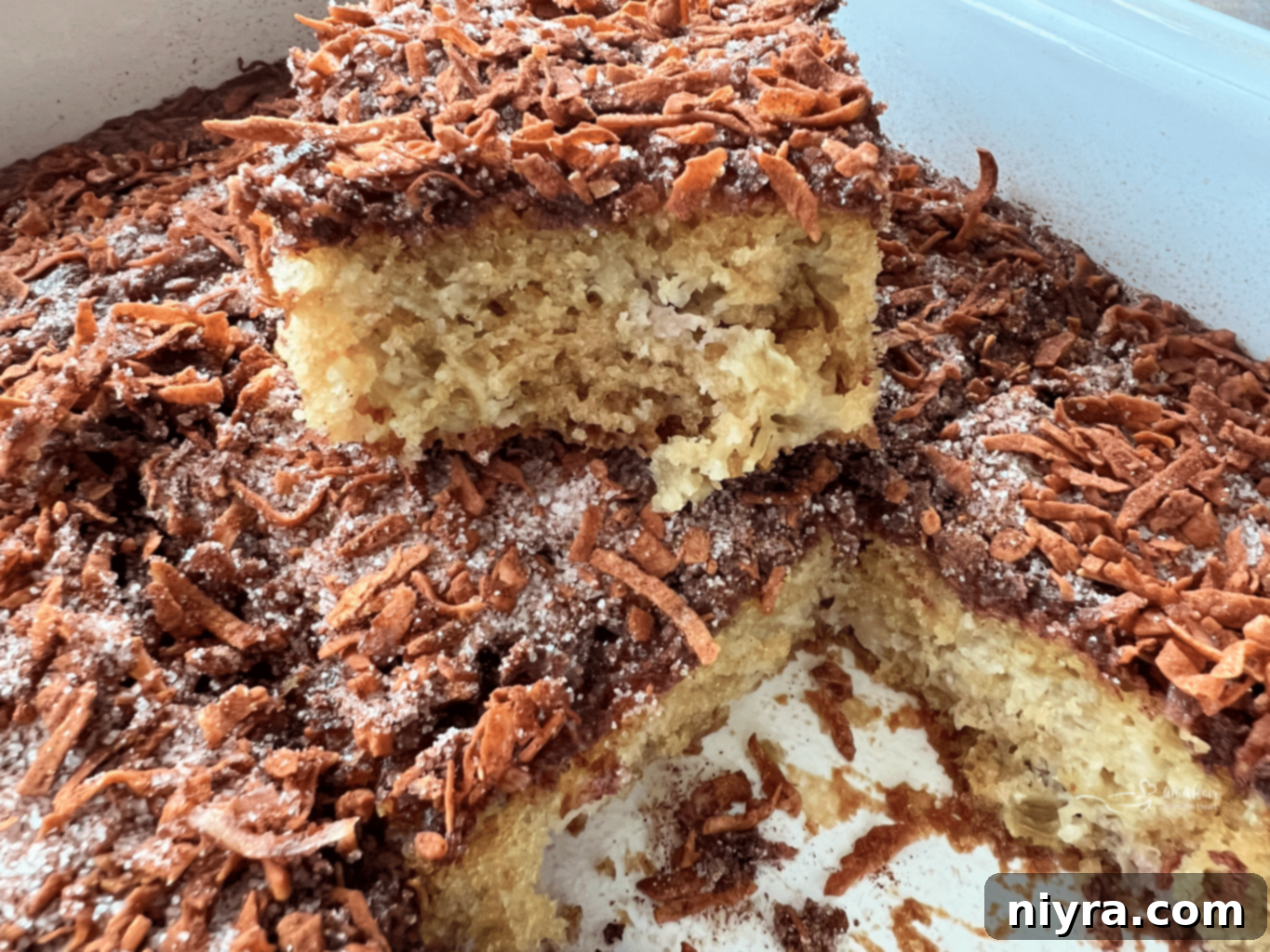 Sweet and Tart Rhubarb Bliss 3 A close-up of a rhubarb cake slice with a fork, showing its moist texture.