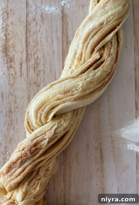 Bloomed Russian Delight 11 Step-by-step photo showing the dough tube sliced lengthwise and twisted.