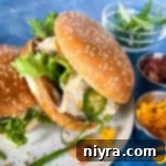 Top view of Instant Pot crack chicken on hamburger buns with lettuce