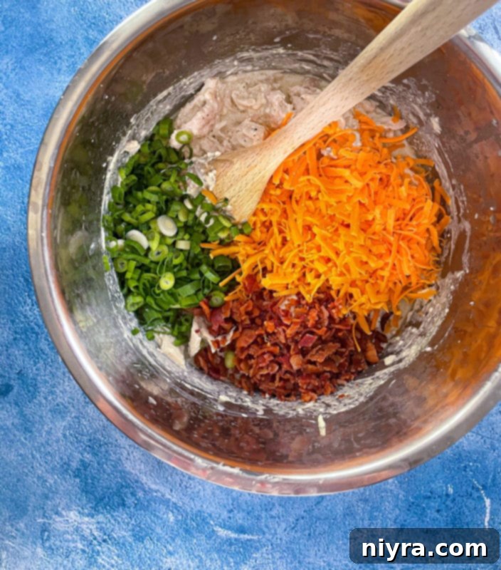 cheddar cheese, bacon, green onions, chicken, ranch dressing mix, and chicken broth in Instant Pot bowl