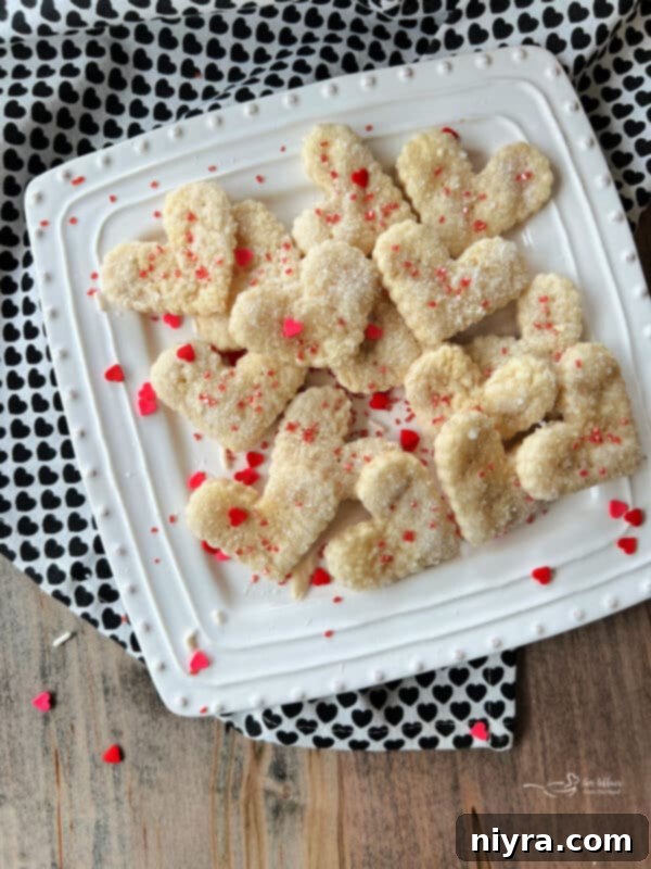 Delicious Pie Crust Cookies sprinkled with sugar, arranged beautifully on a plate.