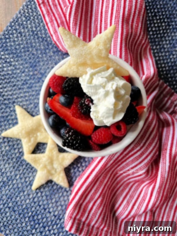 Deconstructed Patriotic Pie with fresh berries, whipped cream, and star-shaped pie crust cookies.