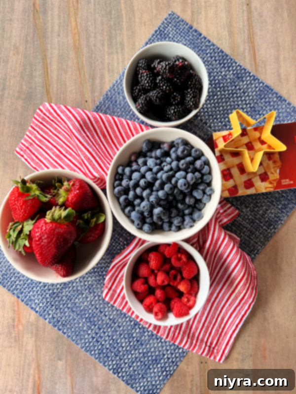 A bowl of Deconstructed Patriotic Pie with mixed berries, whipped cream, and star cookies.