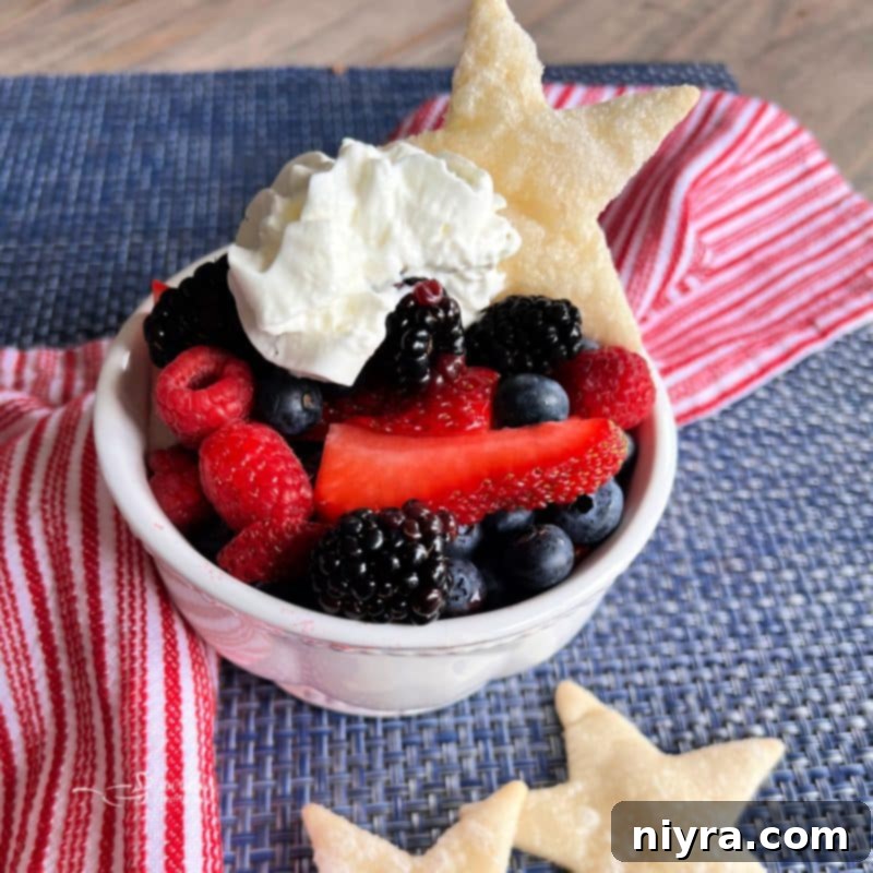 Red, white, and blue berries arranged at the bottom of a white bowl.