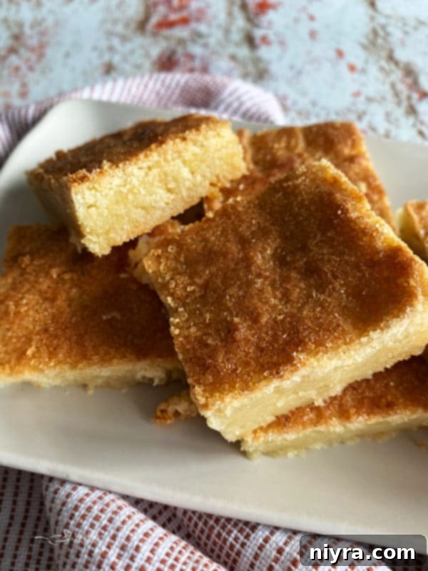 Dutch Almond Letter Bars 12 Close-up view of a beautifully arranged stack of Dutch Letter bars on a clean white plate with a subtle linen texture.
