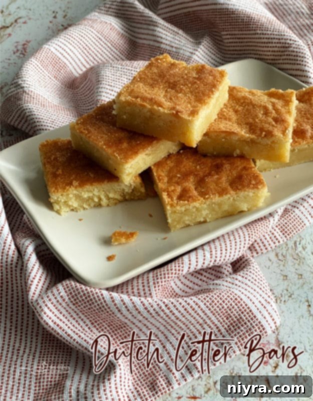 Dutch Almond Letter Bars 14 Front view of a stack of Dutch Letter bars, beautifully arranged on a white plate with a textured linen, inviting a taste.