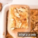 Dutch Almond Letter Bars 16 A Dutch Letter bar on a serving spoon, highlighting its golden crust and soft interior.