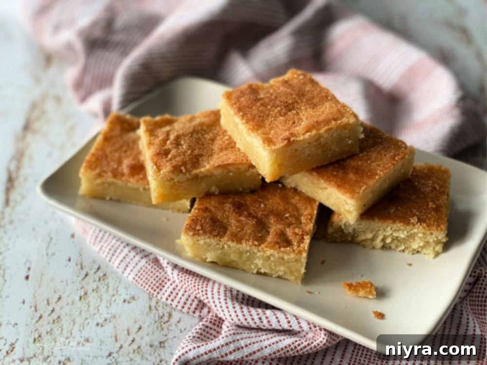 Dutch Almond Letter Bars 10 Front view of a neat stack of Dutch Letter bars on a white plate, showcasing their perfect golden-brown tops.