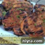 Succulent Apple Moonshine Glazed Pork Chops 12 Close up of pork chops on a white platter with text "Apple moonshine glazed pork chops"