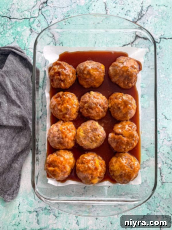 Top view of baked ham balls with sauce