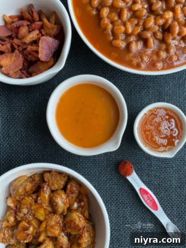 A colorful array of fresh ingredients for Meat Lovers Baked Beans, including bacon, brats, onion, honey, paprika, and Dorothy Lynch dressing