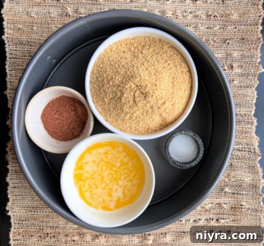 All the fresh ingredients for Irish Cream Cheesecake, including cream cheese, chocolate, and Bailey's, arranged on a rustic wooden surface