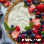 Effortless & Elegant No-Bake Fruit Tart 15 Top view of no bake fruit tart with fresh blueberries, strawberries, blackberries, and raspberries