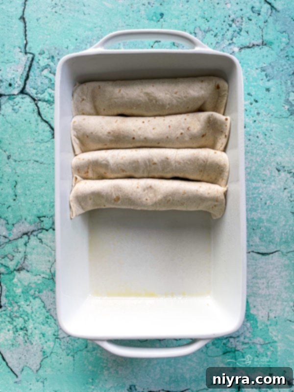 Four enchiladas in white dish