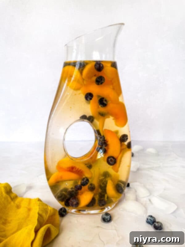 Rose Sangria pitcher with fruit and wine glasses