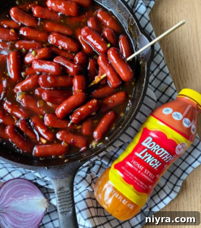 Dorothy's BBQ Little Smokies cooking on a grill in a skillet