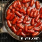 Dorothy's BBQ Little Smokies on a grill in a cast iron skillet