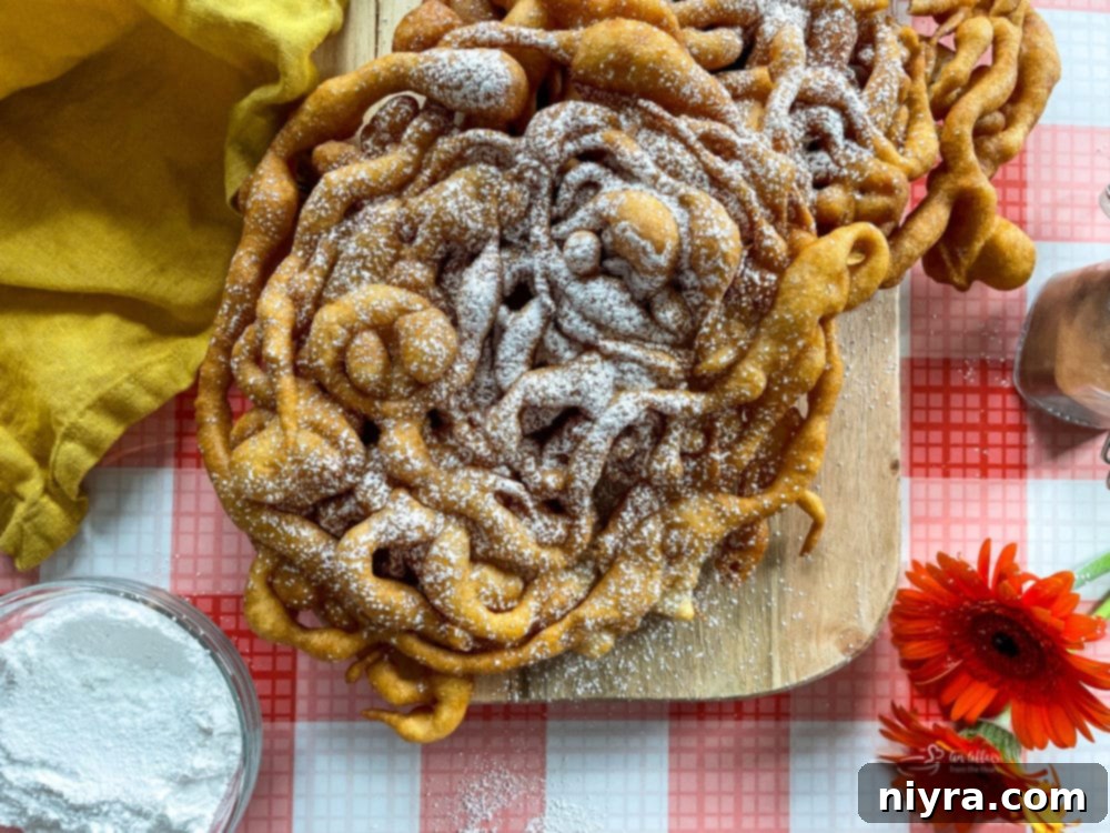 A rustic wooden board holds a large, perfectly fried funnel cake, generously dusted with powdered sugar, ready to be served.