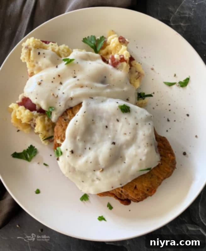 Country fried steak with gravy, mashed potatoes, and corn pie
