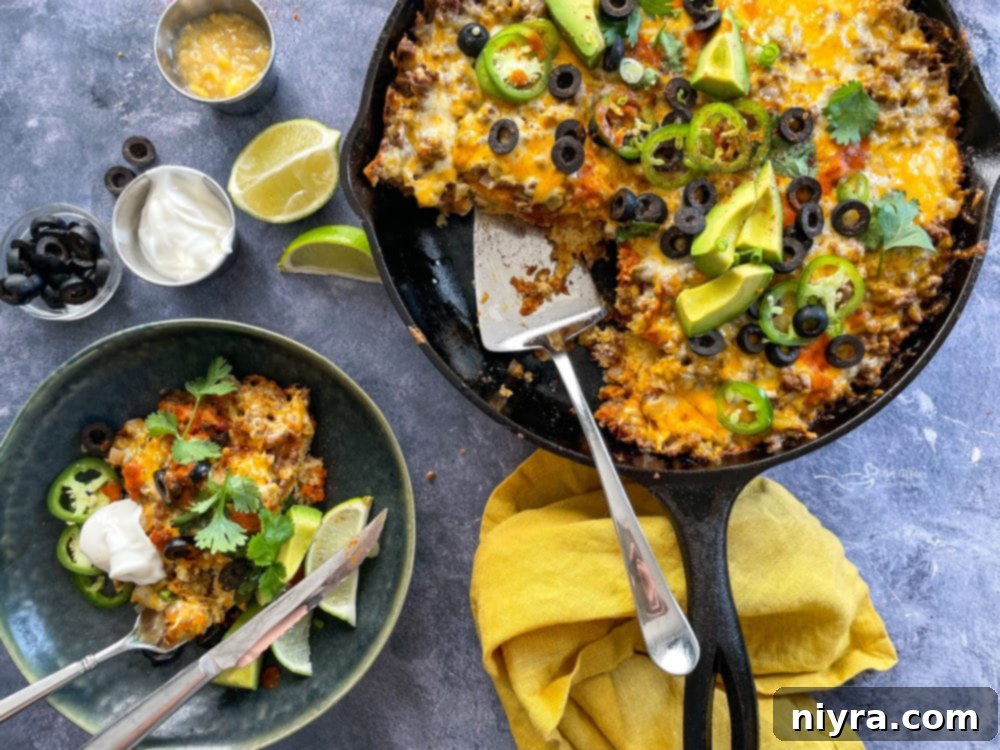 Easy Skillet Tamale Pie Video Tutorial 3 close-up of a portion of tamale pie in skillet, showcasing the cornbread and meat layers