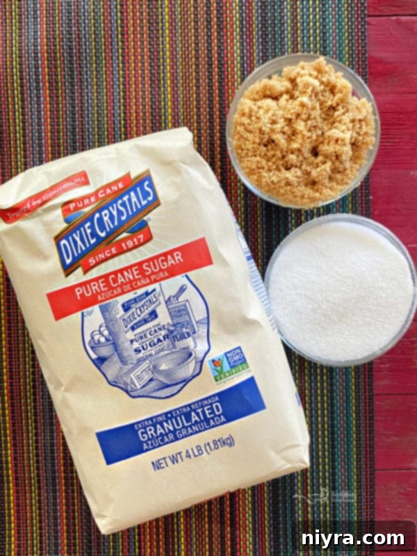 Butterscotch Cookie Ingredients Close-up of granulated sugar and brown sugar side-by-side on a rustic surface, key ingredients for butterscotch cookies.