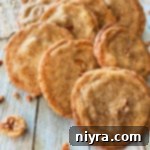 Pecan Butter Cookies lined up on a wood table