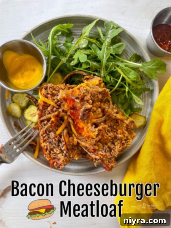 A beautifully presented slice of Paula Deen's Bacon Cheeseburger Meatloaf, glistening with its savory topping, ready to be served and enjoyed.