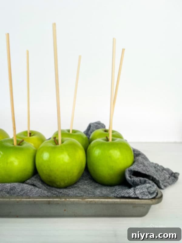 Preparing apples with sticks for dipping