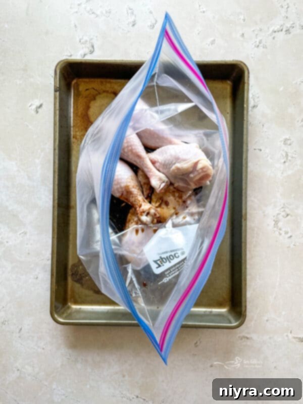 Marinade being poured over chicken in a ziploc bag