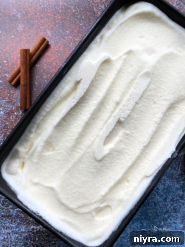 Spiced Vanilla Dream 8 Homemade ice cream being scooped from a loaf pan.