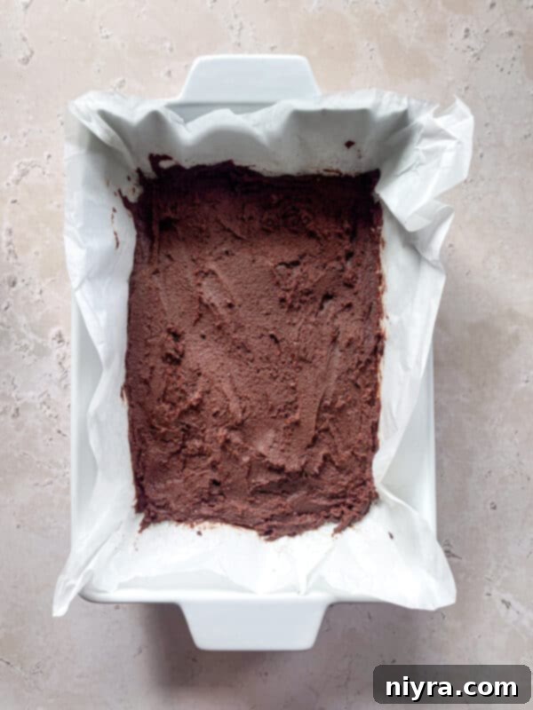 Brownie batter poured into a baking pan