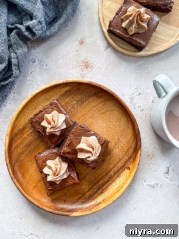 Mexican Chocolate Frosted Brownies sliced on a plate