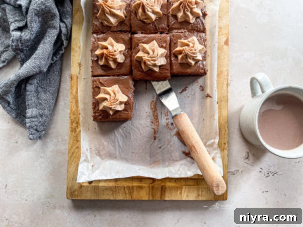 Mexican Chocolate Frosted Brownies sliced on a white board