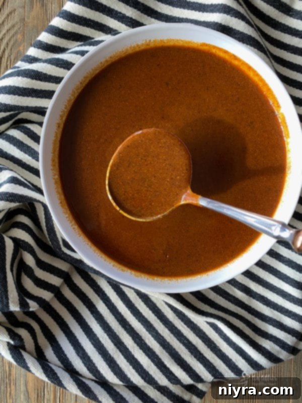 Whisking homemade enchilada sauce in a saucepan