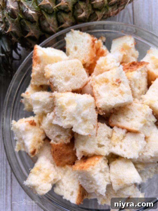 Cutting angel food cake into chunks with a serrated knife