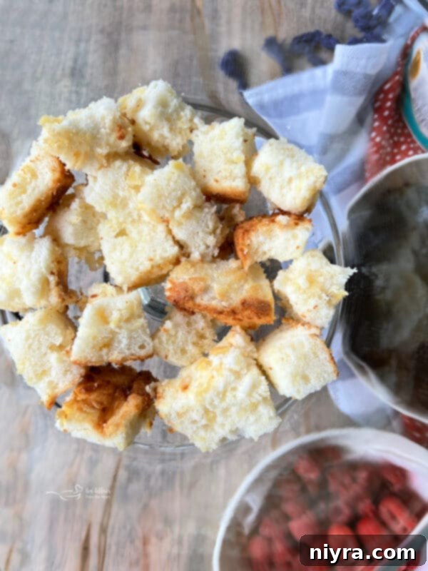 First layer of cubed angel food cake in the bottom of a trifle dish