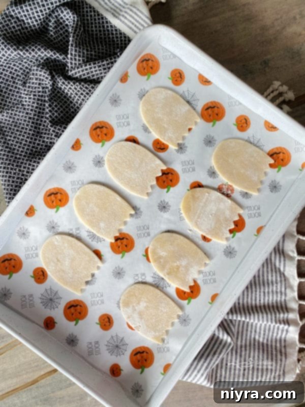 Arranging pop tart ghost cutouts on baking sheet