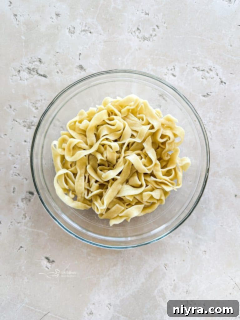 Cooked homemade egg noodles, ready to be added to the soup.