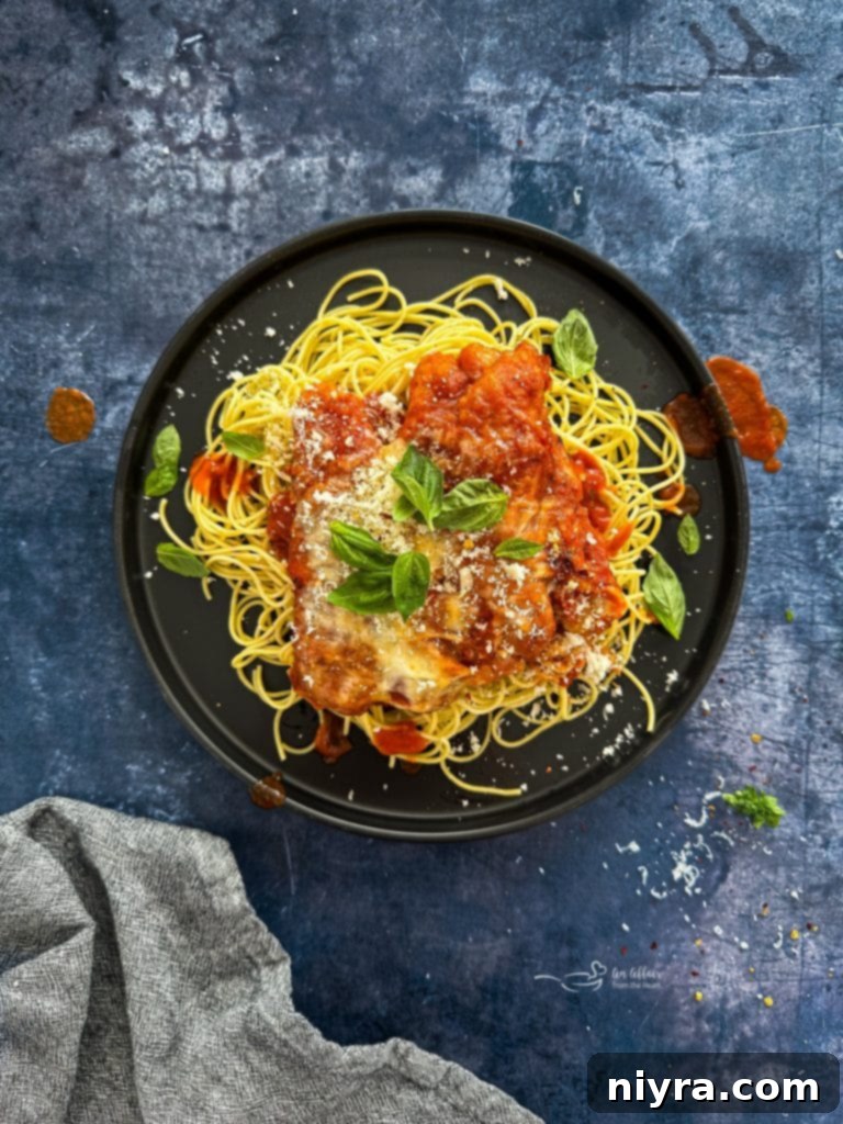Easy Weeknight Chicken Parmesan on a plate with pasta