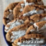 iced molasses ginger cookies in blue container