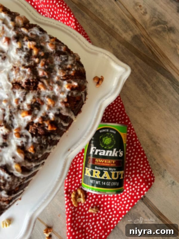 A slice of Bittersweet Chocolate Coffee Cake on a white plate, showcasing the streusel swirl and glaze.